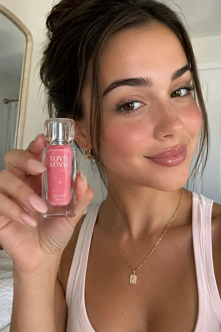 UGC-style selfie holding the lip gloss
